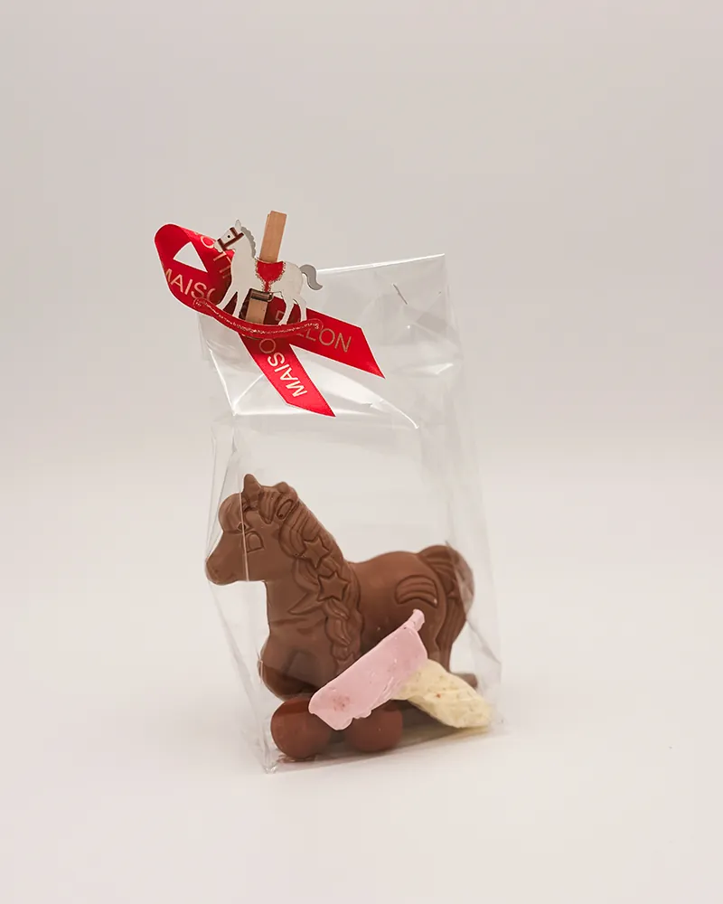 Chocolade paardje met een snoepje in een zakje met rood lint